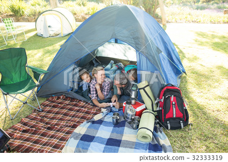 Family looking at camera in the tent Family looking at camera in the tent 32333319