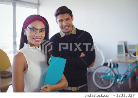 Portrait of happy young business colleagues at office Portrait of happy young business colleagues at office 32333327
