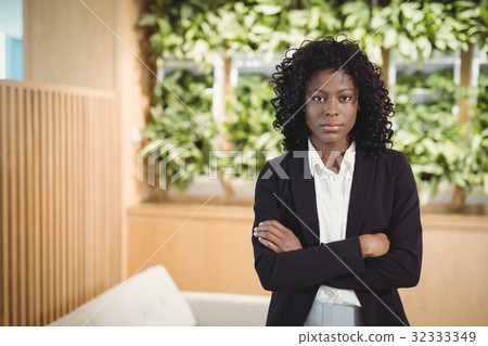 Portrait of executive standing with arms crossed 32333349