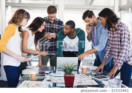 Creative business team discussing around table Creative business team discussing around table 32333461