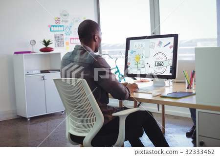 Businessman using computer in creative office Businessman using computer in creative office 32333462