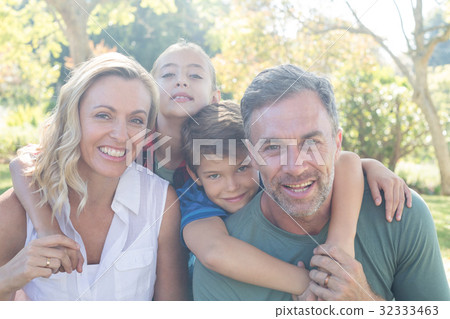 Happy family in park on a sunny day Happy family in park on a sunny day 32333463