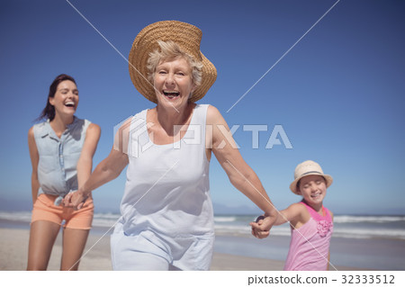 Cheerful multi-generation family at beach 32333512