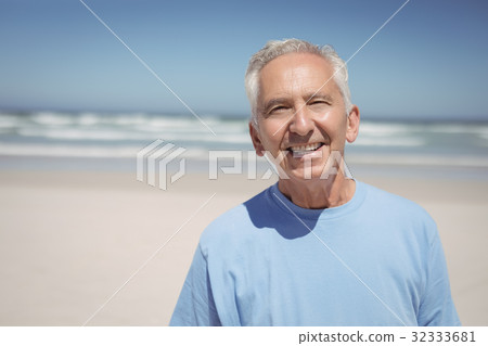 Portrait of smiling senior man at beach 32333681