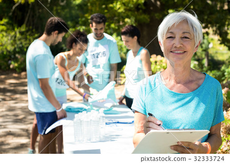 Coach smiling while athletes registering for marathon 32333724