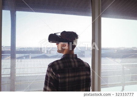 Businessman wearing virtual reality headset in office 32333777