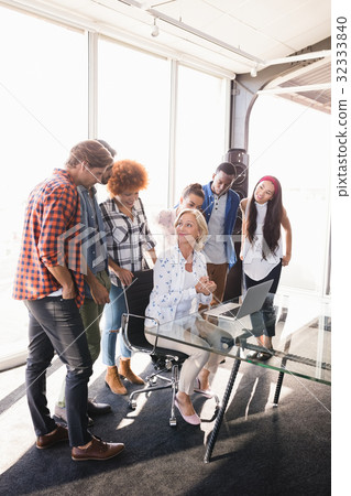 Businesswoman interacting with creative team Businesswoman interacting with creative team 32333840