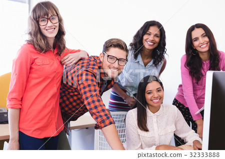 Portrait of business people working over desktop computer 32333888