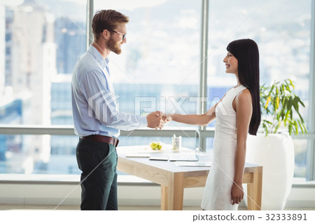 Executives shaking hands with each other in office 32333891