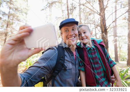 Happy father and son taking selfie from mobile phone Happy father and son taking selfie from mobile phone 32333921