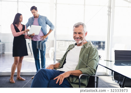 Portrait of businessman sitting on chair 32333973