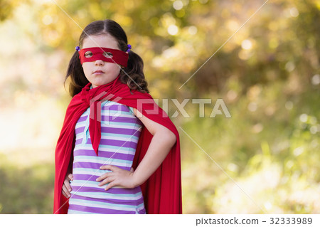 Little girl wearing superhero costume at campsite Little girl wearing superhero costume at campsite 32333989