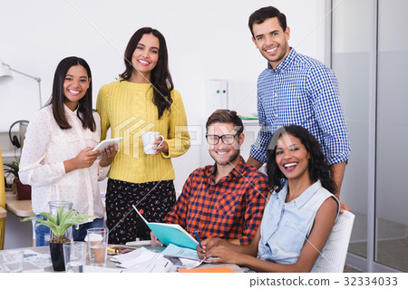 Portrait of happy business people at desk Portrait of happy business people at desk 32334033