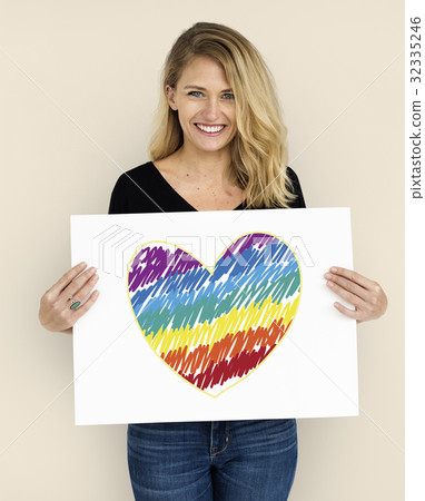 Woman holding placard with LGBT heart icon 32335246