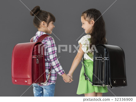 Girl and her friend are going to school Girl and her friend are going to school 32336900