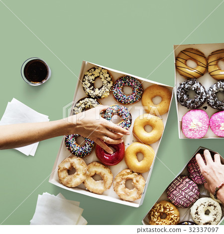 Group of hands holding sweeten donut dessert Group of hands holding sweeten donut dessert 32337097