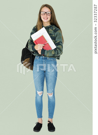 Teenage girl student smiling and holding textbook 32337287