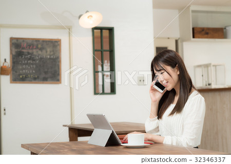 A woman working in a cafe A woman working in a cafe 32346337