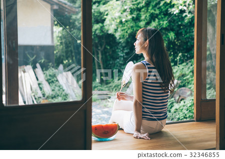 A woman caressing a fan at the edge 32346855
