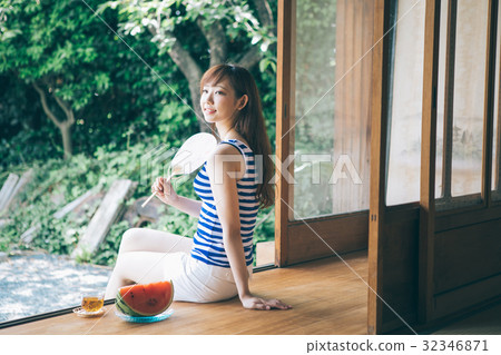 A woman caressing a fan at the edge 32346871