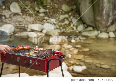 Barbecue at the waterside Char-grilled meat roasted with thick sausages 32347409