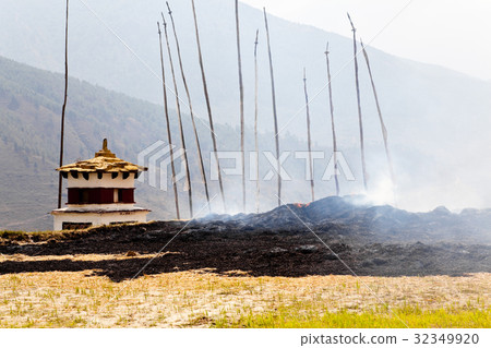 Burning straw near the prayer wheel at Punakha 32349920