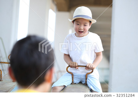 Children playing with a seesaw Children playing with a seesaw 32351284