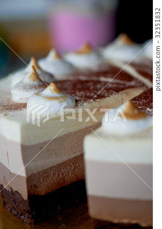 four layer cake with shades of brown.Here cream to 32351832