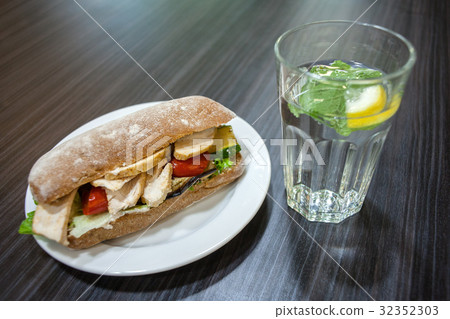 Sandwich on a plate and a glass of water Sandwich on a plate and a glass of water 32352303
