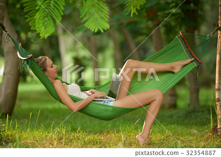 Using Laptop in Tropical Park Using Laptop in Tropical Park 32354887