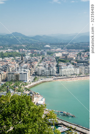Spain The streets of the red-brown roof building overlooking the mountain of San Sebastian, the coastline and the mountains seen far away 32356489