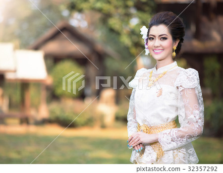 Beautiful Thai girl in Thai traditional costume Beautiful Thai girl in Thai traditional costume 32357292