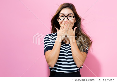 Surprised young woman posing 32357967