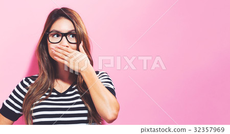 Young woman covering her mouth 32357969