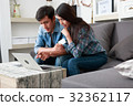 Happy couple online shopping at home 32362117