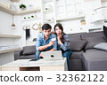 Happy couple online shopping at home 32362122