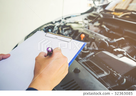 mechanic holding a clipboard of service mechanic holding a clipboard of service 32363085