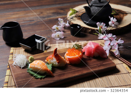 Sushi Set sashimi and sushi rolls with tea on wood background Sushi Set sashimi and sushi rolls with tea on wood background 32364354