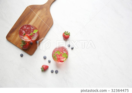 Strawberry juice cocktail with ice and mint on white tone amd wooden Strawberry juice cocktail with ice and mint on white tone amd wooden 32364475
