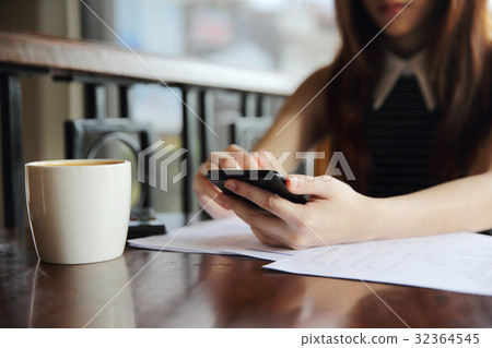 Young business woman with smartphone and coffee Young business woman with smartphone and coffee 32364545