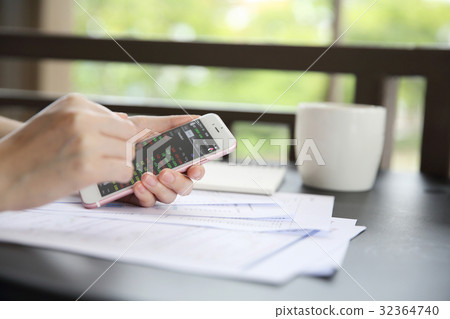 trading online on smartphone with bussiness woman hand trading online on smartphone with bussiness woman hand 32364740