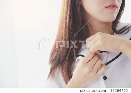 Asian young school girl dressing in bedroom 32364763