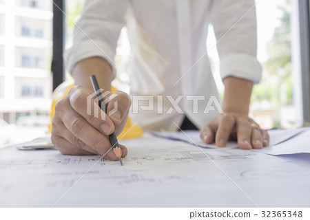 Engineer sketch architectural project on blueprint 32365348