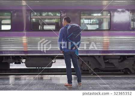 man traveler with backpacker at trainstation man traveler with backpacker at trainstation 32365352