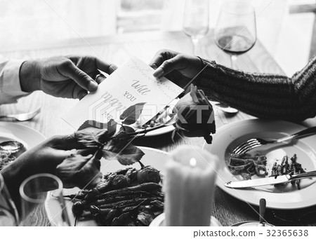 Romantic Man Giving Will You Marry Me Card with a Rose to Propose Woman Romantic Man Giving Will You Marry Me Card with a Rose to Propose Woman 32365638