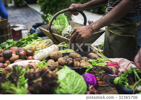 People selecting a vagetable from a table People selecting a vagetable from a table 32365706
