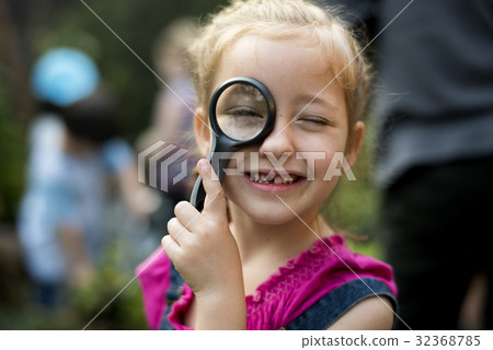 Kid is using magnifier studying Kid is using magnifier studying 32368785