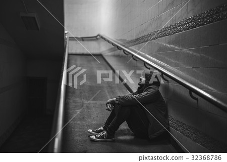 Cold Adult Man Sitting Hopeless Thoughtful on the Ramp Cold Adult Man Sitting Hopeless Thoughtful on the Ramp 32368786