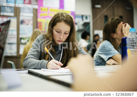 Young woman writing note in classroom 32368867