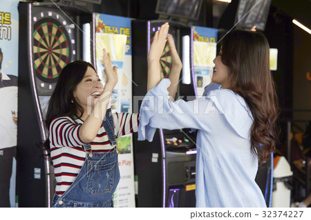 Young girl, darts, game center 32374227